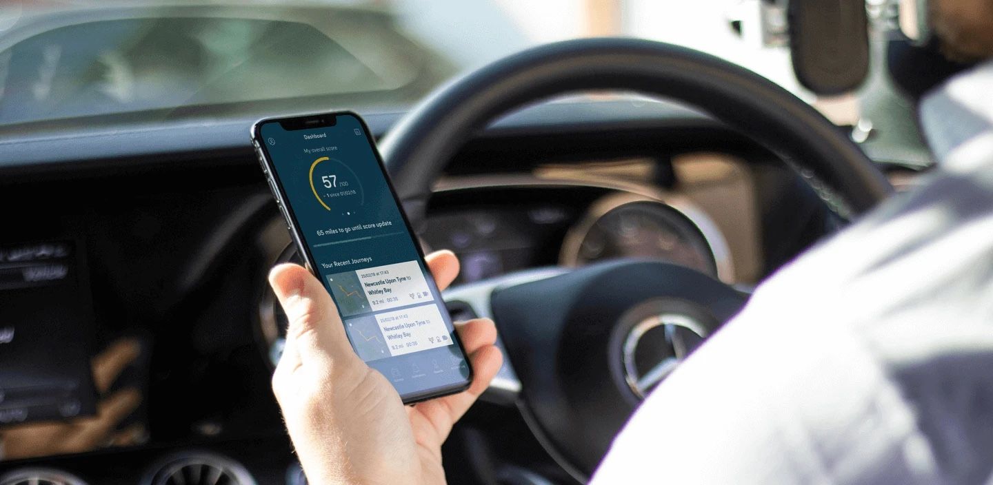 The Theo app showing a driver's overall driving score and their recent journeys.