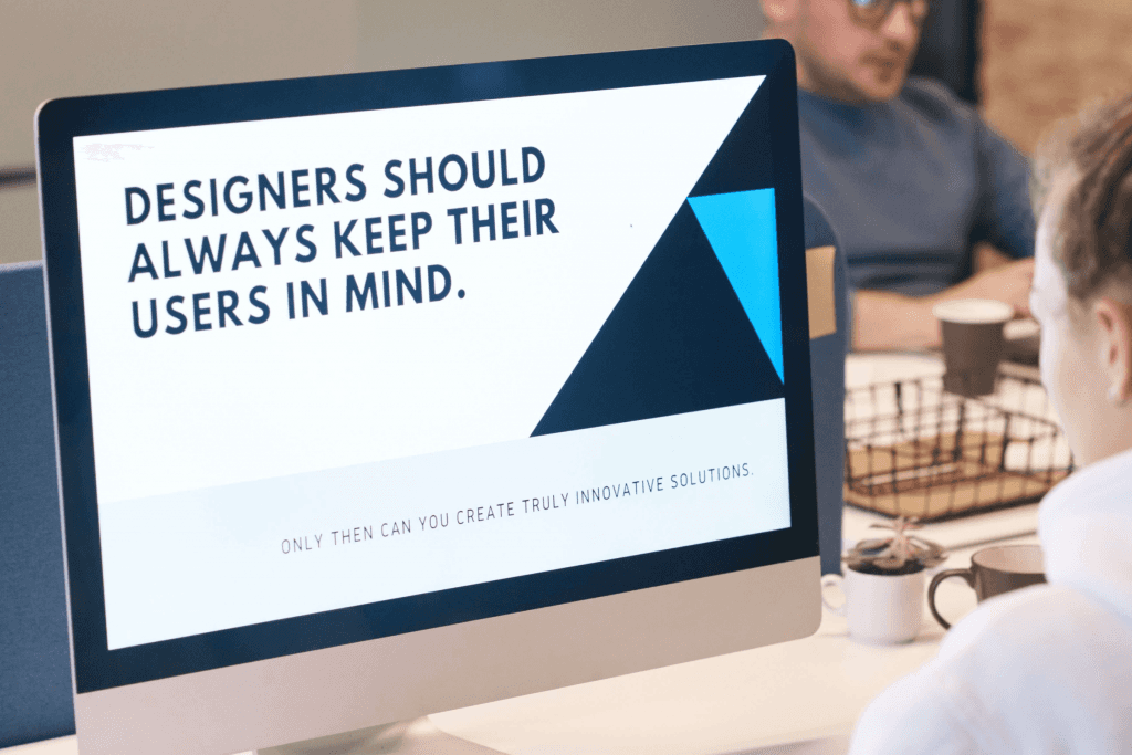 A person sat in an office at a Mac computer typing. The image on the computer screen reads Designers should always keep their user in mind. Only then can you create truly innovative solutions.