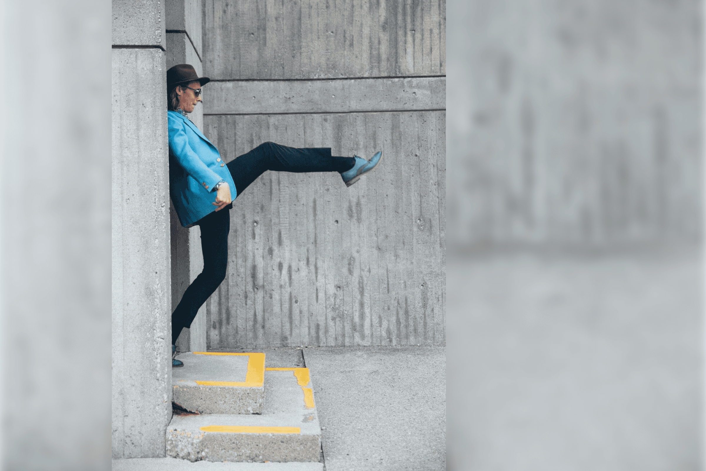 A person standing on a step lifting one of the leg
