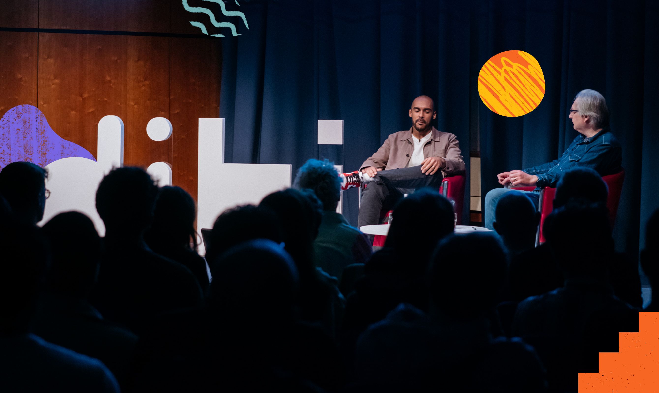 A panel conversation on the DIBI stage in front of the dibi letterforms